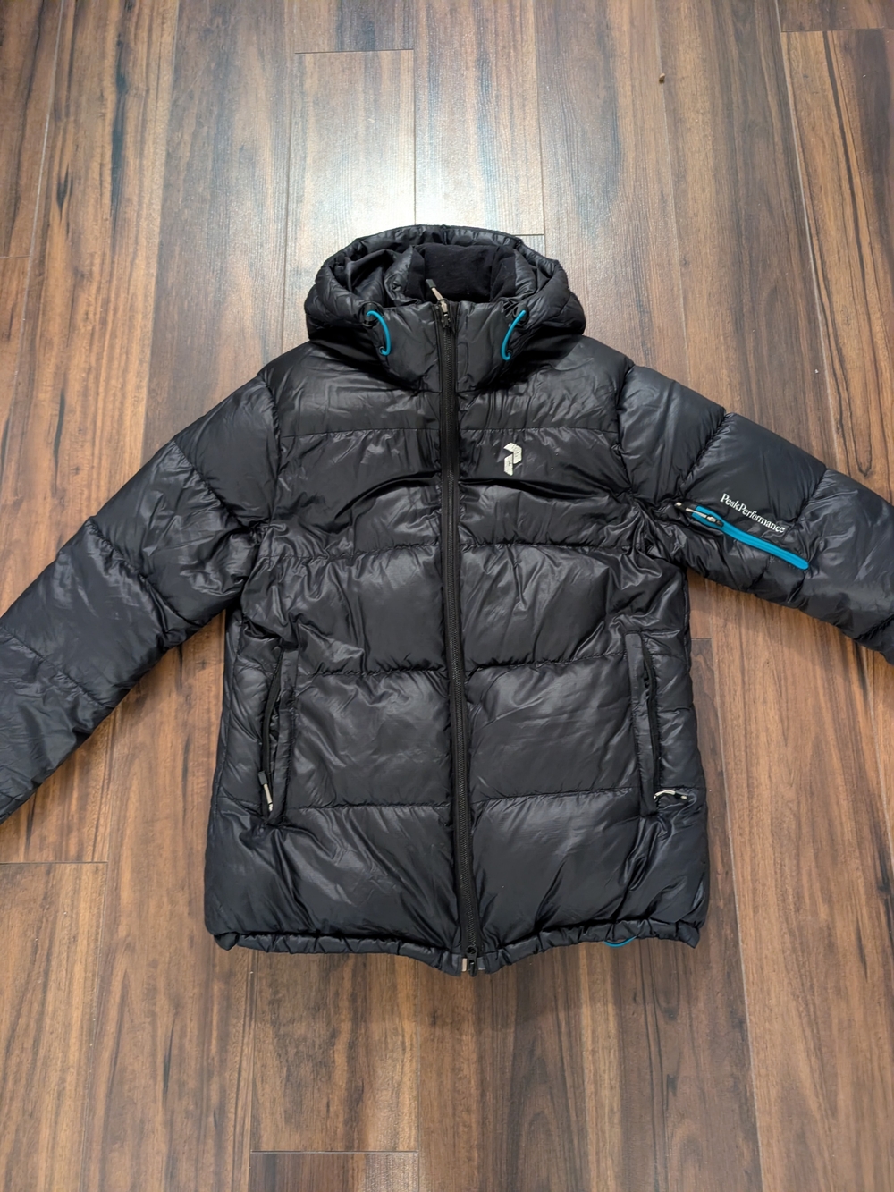 Peak Performance Black Hooded Puffer Jacket with Teal Accents